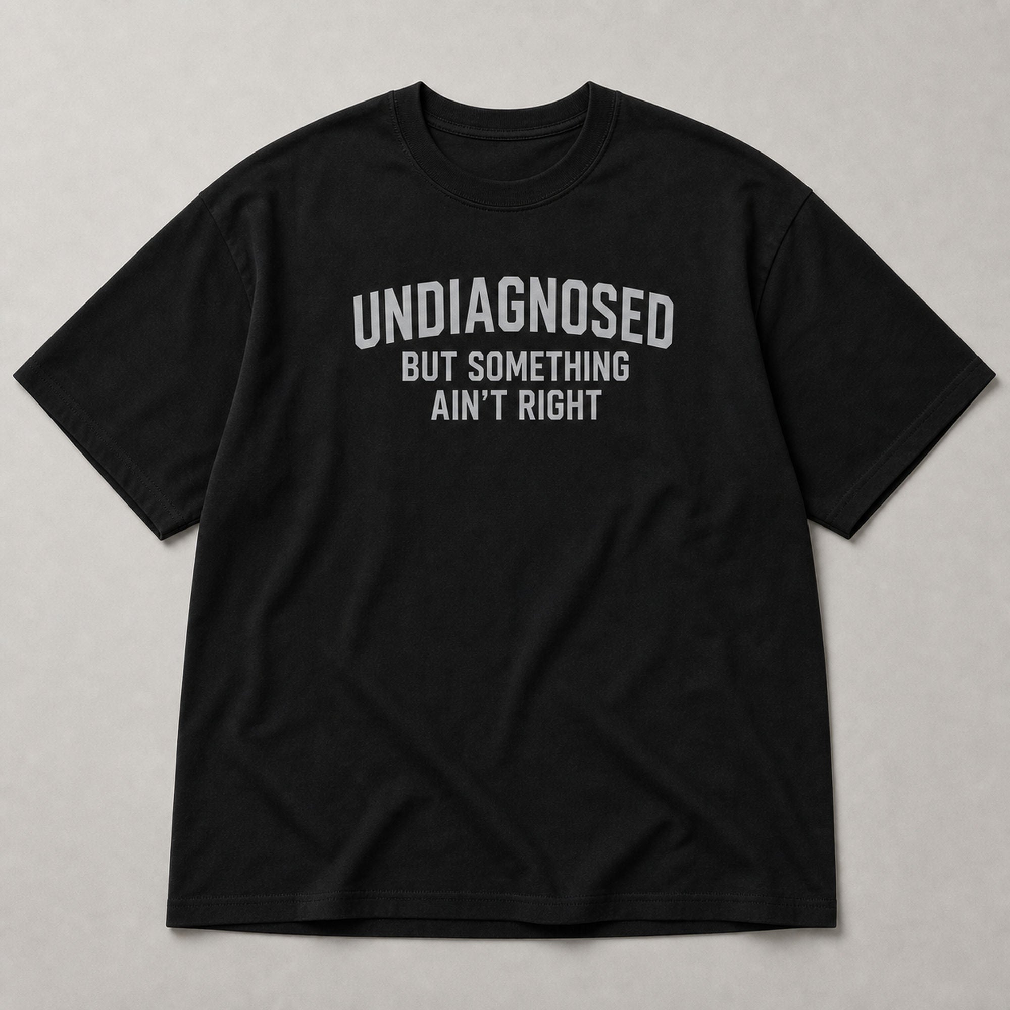 Undiagnosed But Something Ain't Right funny graphic tee black front flat lay